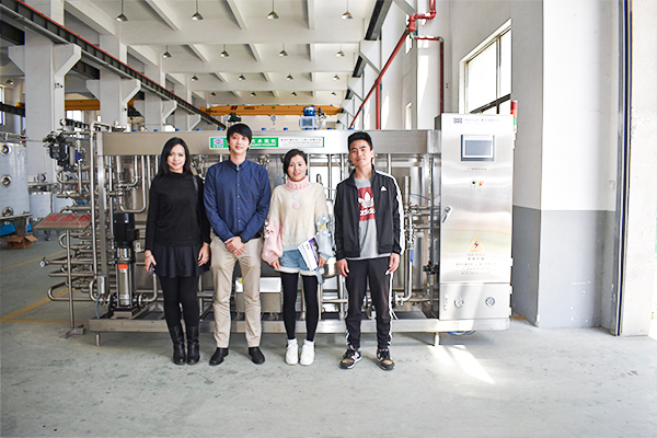 group photo of customers with water production line equipment